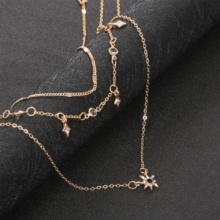 Gold-tone layered star pendant necklace with dangling star charm and chain