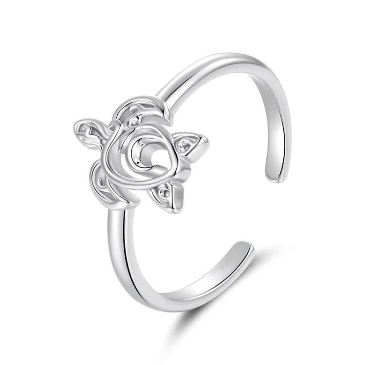 Adjustable open cuff ring with raised ocean-life motif, silver-tone, close-up angle