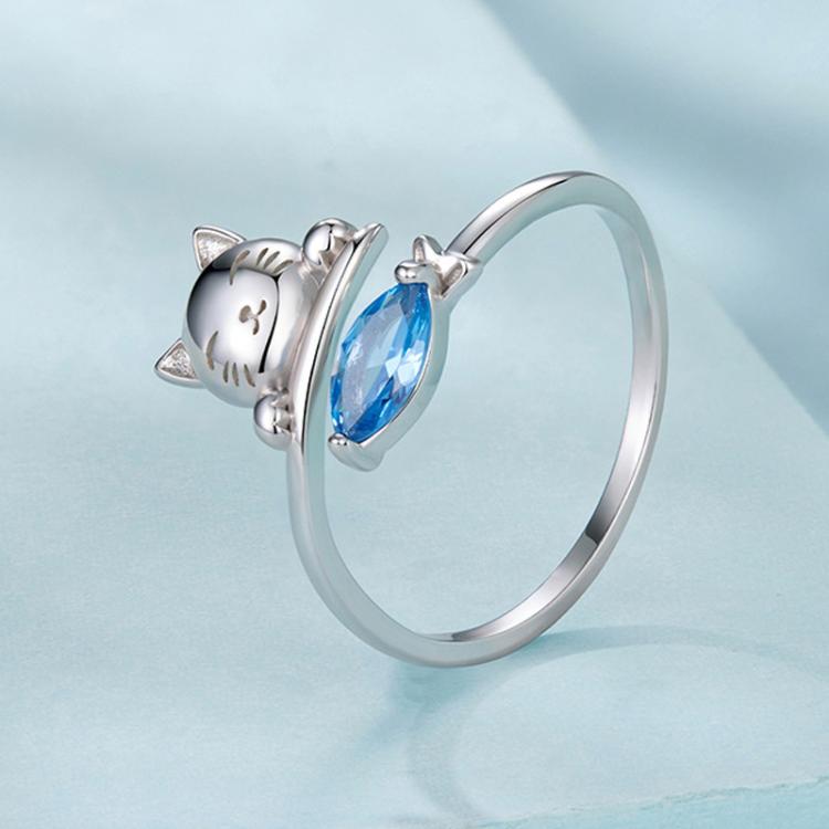 Silver-tone open cat ring with blue teardrop zircon and fish motif, rounded band