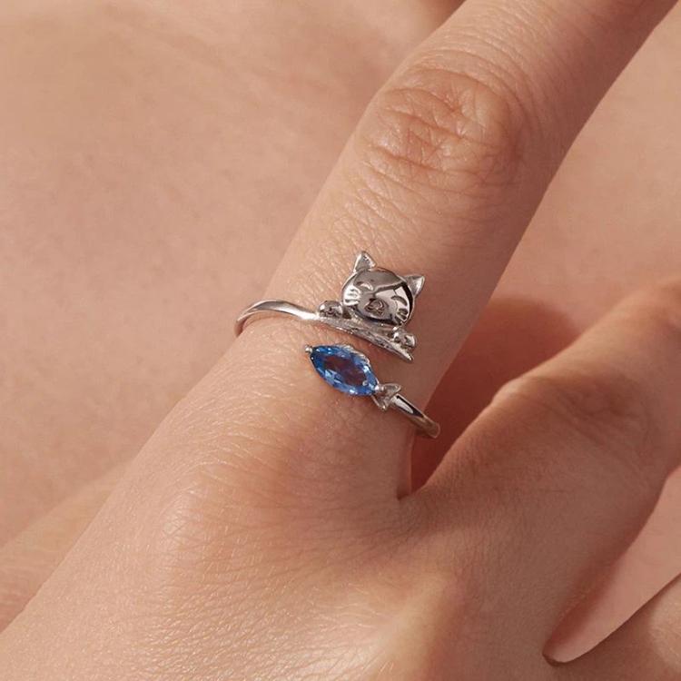 Cat motif open ring with blue zircon stone on hand, silver-tone finish