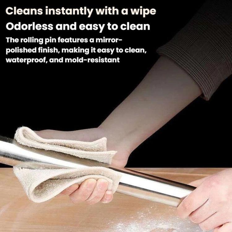 Stainless steel rolling pin being wiped clean with a cloth