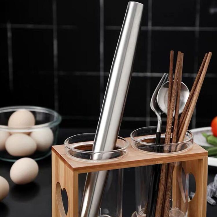 Stainless steel rolling pin standing in a wooden kitchen utensil holder
