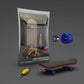 Finger skateboard toy with dark blue wheels and wooden deck, shown in retail box