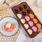 Brown silicone heart chocolate mold with filled hearts in white, pink, and orange