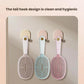 Set of three hair massage combs in white, blue, and pink hanging by hooks