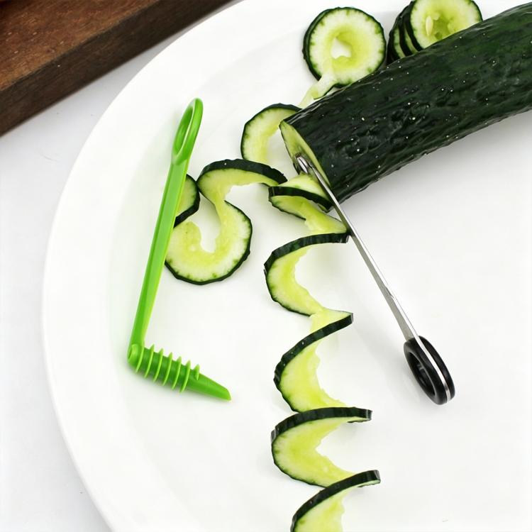 Spiral cucumber slicer tool with green plastic handle and metal cutting auger