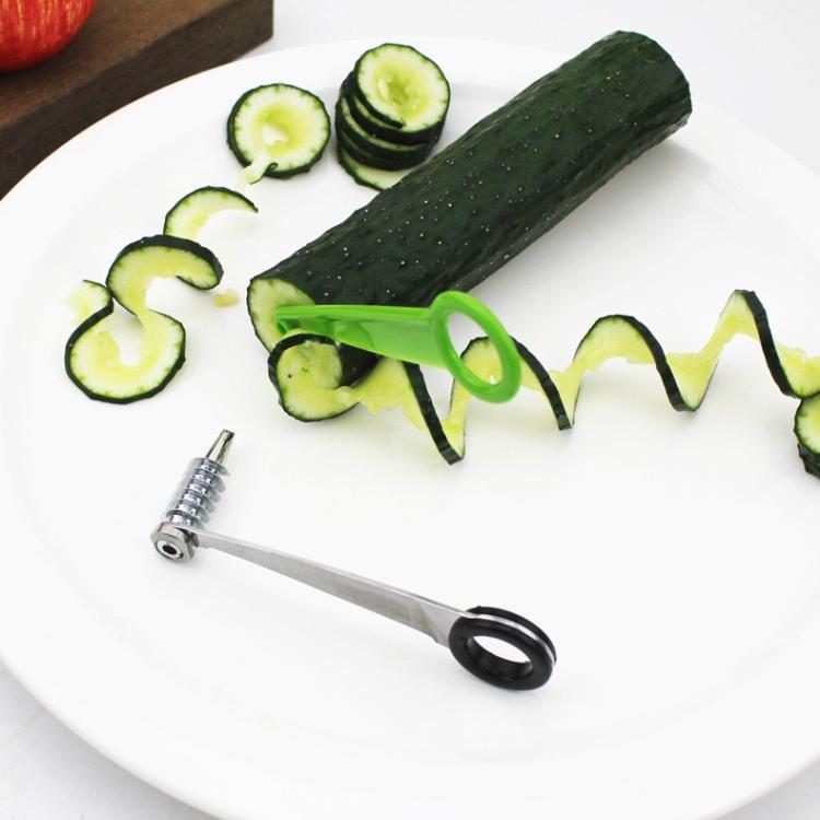 Spiral cucumber slicer with green handle and spiral-cut cucumber on a plate