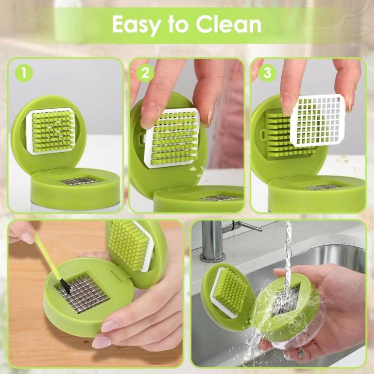 Green manual garlic press cleaning with removable grater parts and water rinse.