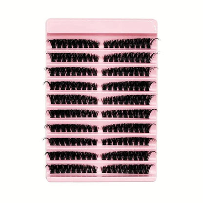 False eyelash clusters in a pink tray, segmented curled lash strips