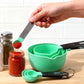 Mint green silicone measuring spoon set with stainless handles and scoop ends