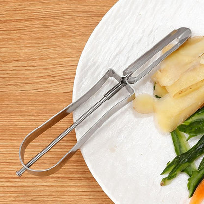 Stainless steel fruit peeler with U-shaped blade, peeling pineapple.
