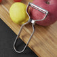 Stainless steel peeler with dual blade bars, held against a lemon on board
