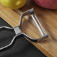 Stainless steel peeler blade assembly with curved frame, angled on cutting board