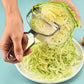 Stainless steel peeler with curved frame, shaving cabbage over a bowl