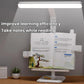 Adjustable white LED desk lamp with tall post and light bar over open book