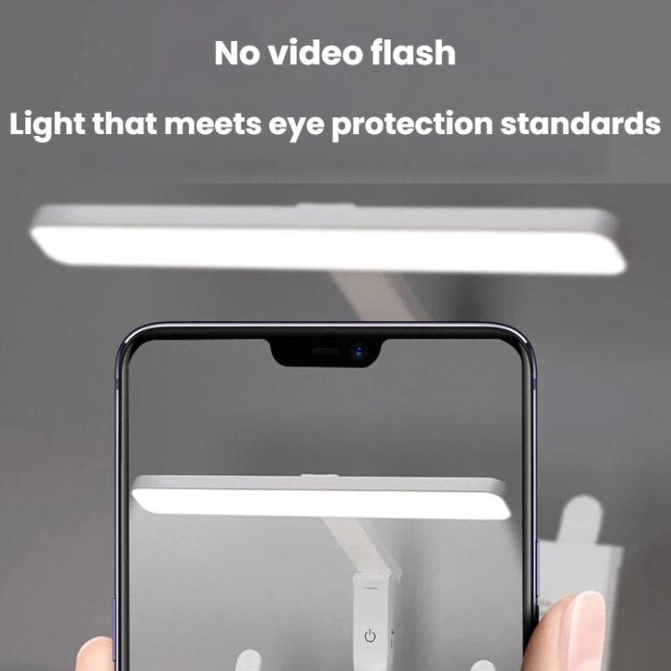 Adjustable LED desk lamp producing a bright light bar over a phone camera view