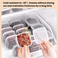 Square freezer containers with clear lids, hands reaching among multiple boxes