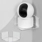 Clear triangular corner shelf holding a white security camera