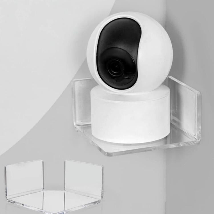 Clear triangular corner shelf holding a white security camera