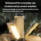 Beige and black foldable LED camping light, shown in wet outdoor conditions
