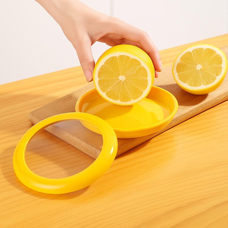 Yellow mini fruit storage container with silicone seal, holding lemon halves