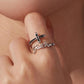 Close-up of adjustable cross ring on finger, black stone accents and Faith script
