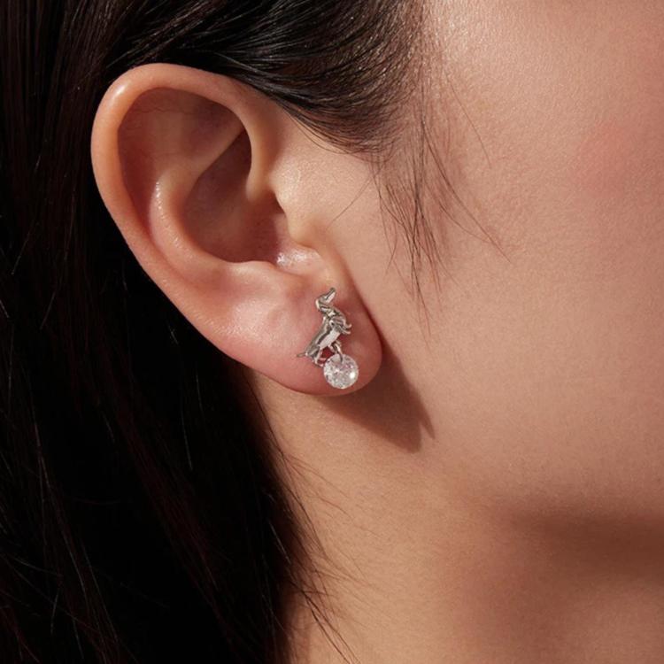 Close-up: silver-tone dachshund drop earrings with round crystal on ear