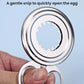 Stainless steel egg peeler with serrated circular blade opening, held over an egg