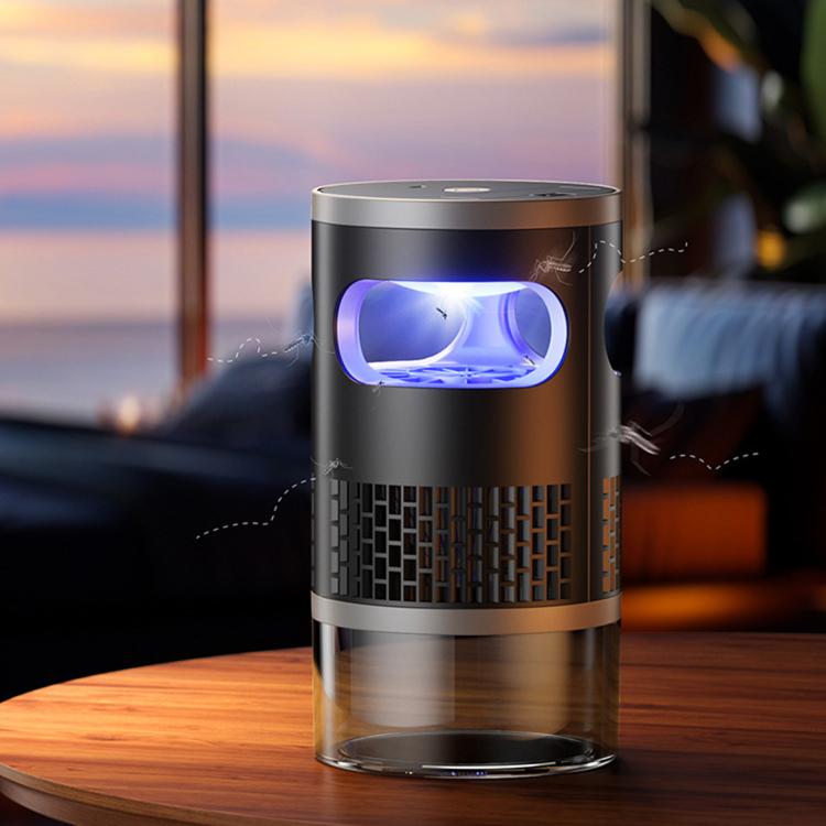 Standing mosquito killer night light on a table with purple glow and transparent base