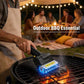 Electric grill cleaner brush being used on a barbecue grill grate with blue light