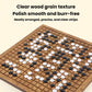 Brown wooden go board with black and white stones arranged on the grid