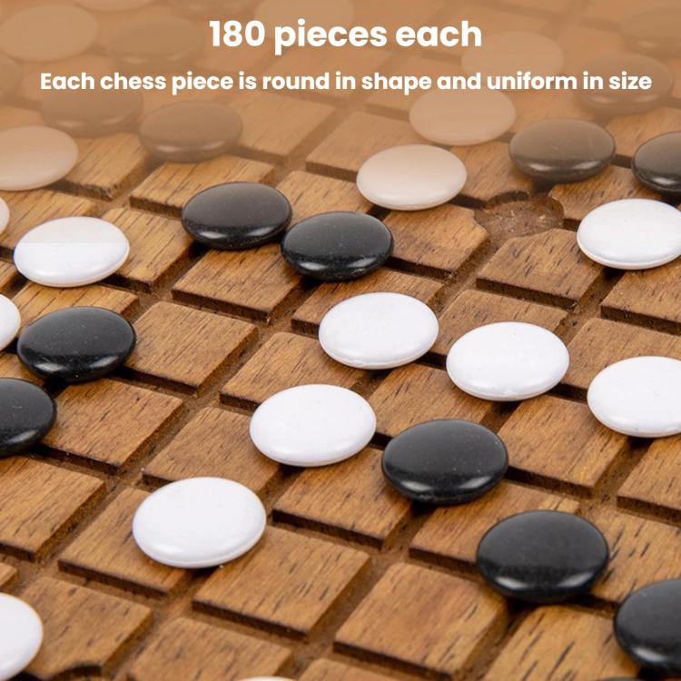 Round black and white game stones on a wooden grid board