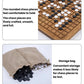 Wooden go board with rounded stones; storage bag holds extra pieces