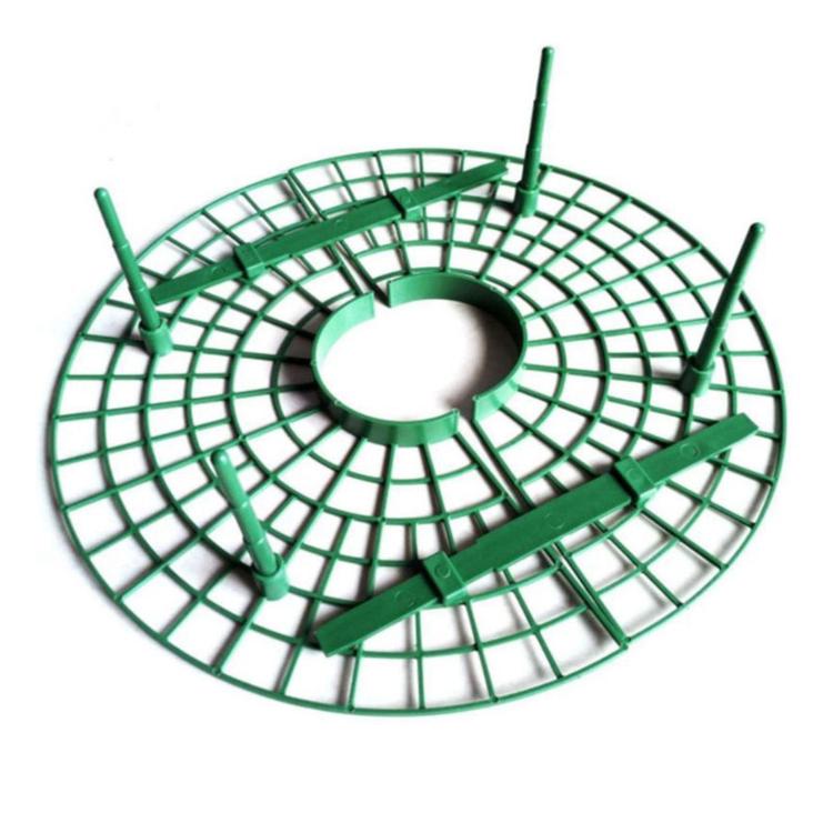 Green round grid fruit cradle with angled bars and short support legs