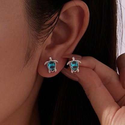 Silver-tone turtle earrings with blue oval gemstone and shell-like frame