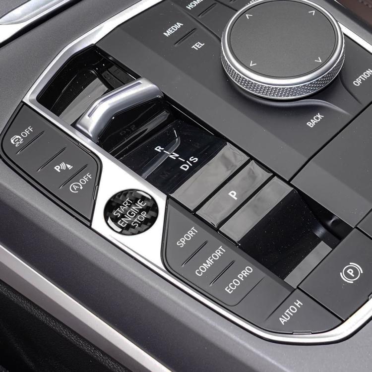 Engine start/stop button area with round “START ENGINE STOP” sticker on car center console