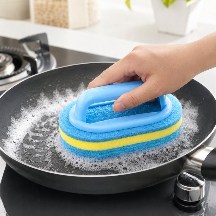 Blue and yellow scrub sponge brush with handle, held over a frying pan