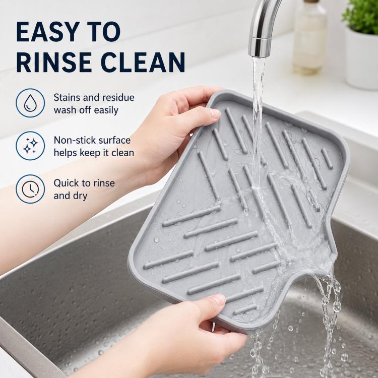Gray silicone sink tray under faucet flow, sloped ridged surface for rinsing
