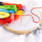 Embroidery hoop with cross-stitch fabric and six-strand threads in bright colors