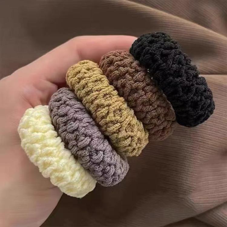 Assorted thick knit hair tie scrunchies held together, pastel and dark brown loops