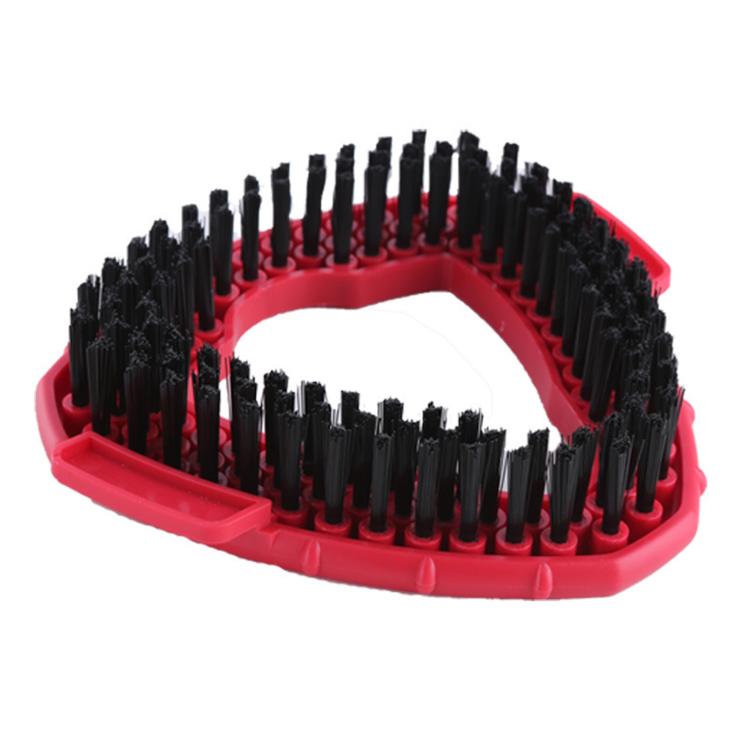 Triangular mop brush head with dense black bristle rows on red plastic frame