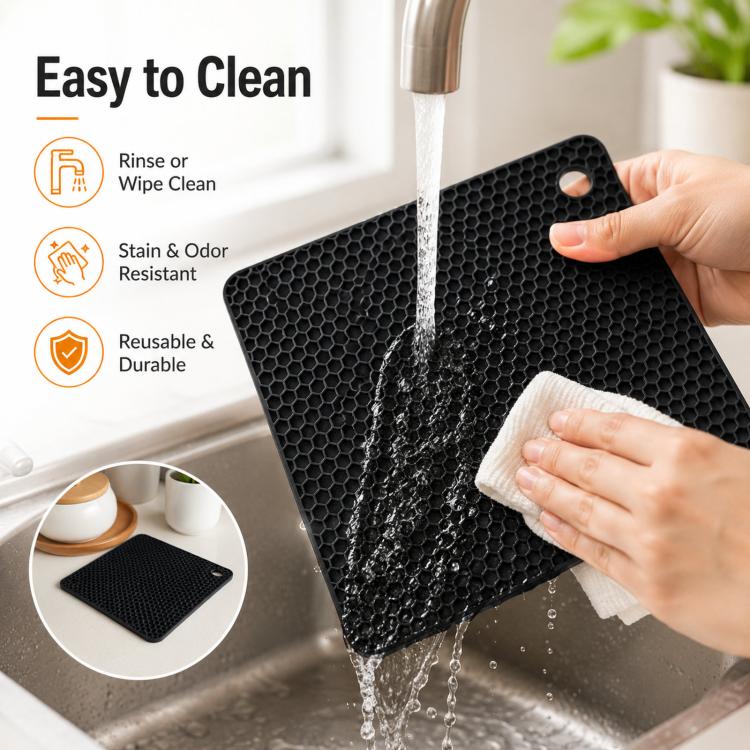 Black square silicone honeycomb table mat coaster being rinsed with water