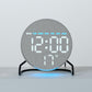 Round LED desk clock in gray fabric with stand, blue glow under base and date readout