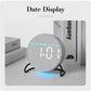 Round LED desk clock with gray fabric face, LED date display and blue ambient light