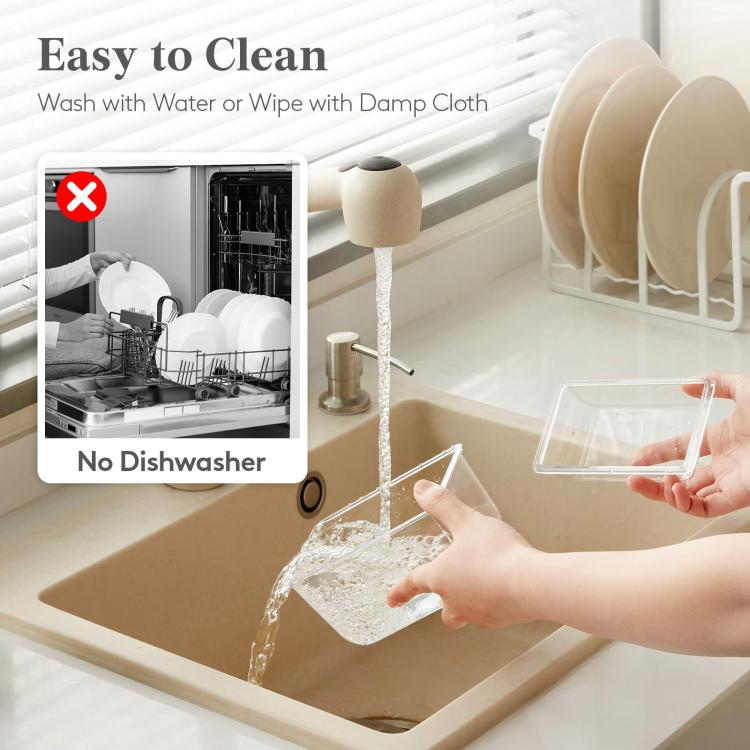 Clear five-compartment freezer tray rinsed with water, showing no dishwasher icon