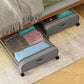 Gray underbed storage container with clear window lid and rolling wheels, close view