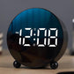Circular LED alarm clock, black round face showing blue LED time digits and PM indicator