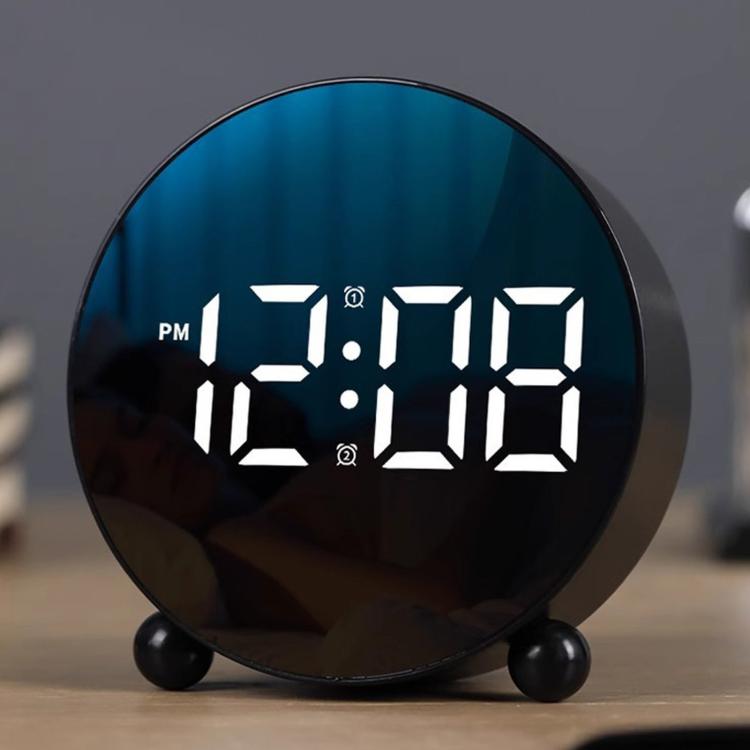 Circular LED alarm clock, black round face showing blue LED time digits and PM indicator