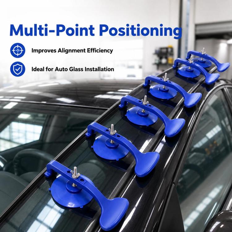 Multiple blue suction cup mounting tools positioned on car window glass