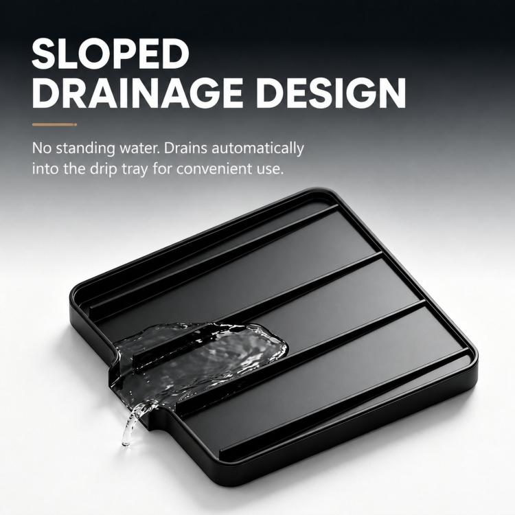 Black sloped espresso drip tray with water channel flowing into the base